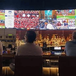 Best IPTV for sports USA — fans watching multiple live games on big screens in a sports bar